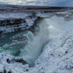 The picture shows the waterfalls of Gullfoss under the snow in Iceland. Source: https://commons.wikimedia.org/wiki/File:Iceland_-_2017-02-22_-_Gullfoss_-_3684.jpg