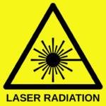 The picture shows a warning sign indicating that a laser beam is operating in the area. Source: https://commons.wikimedia.org/wiki/File:Laser-symbol-text.svg